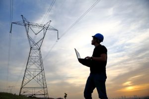 6-Engineer With PC Looking at Transmission Line At Dawn iStock_91714253_XXXLARGE Asset Management to provide safe and reliable electricity